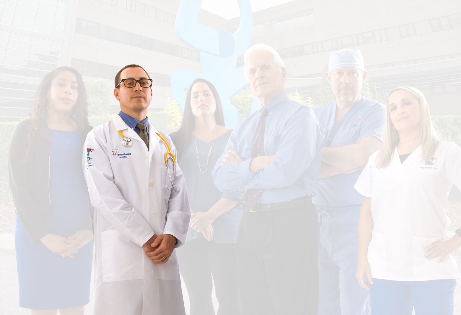 A doctor wearing a white lab coat with a Northwell Health logo separates from the rest of the team and the background.